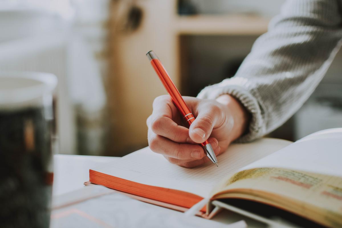 Person writing in a book